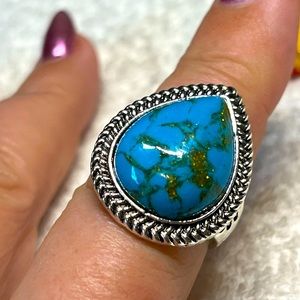 Imitation turquoise ring with flower on the side -pear shaped